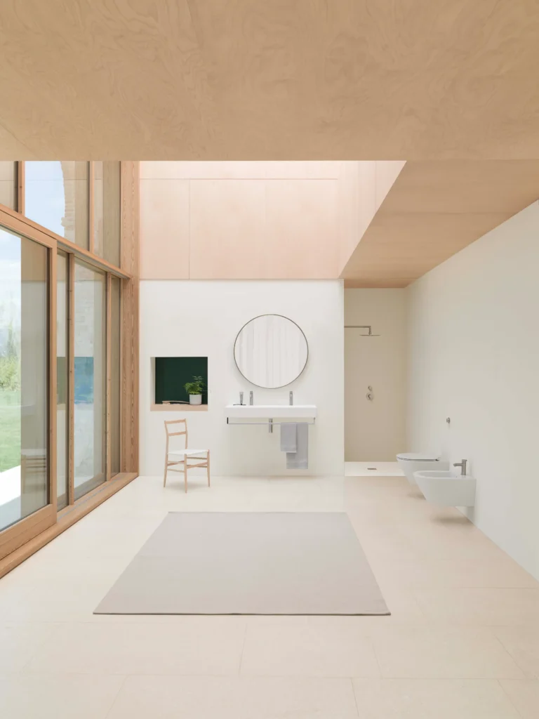 Minimalist bathroom with natural light - solid surface baths and basins